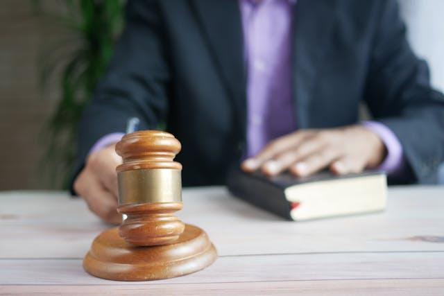 a person banging a gavel with their hand on a book