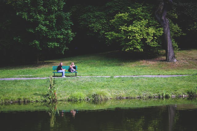 two people sitting in a park
